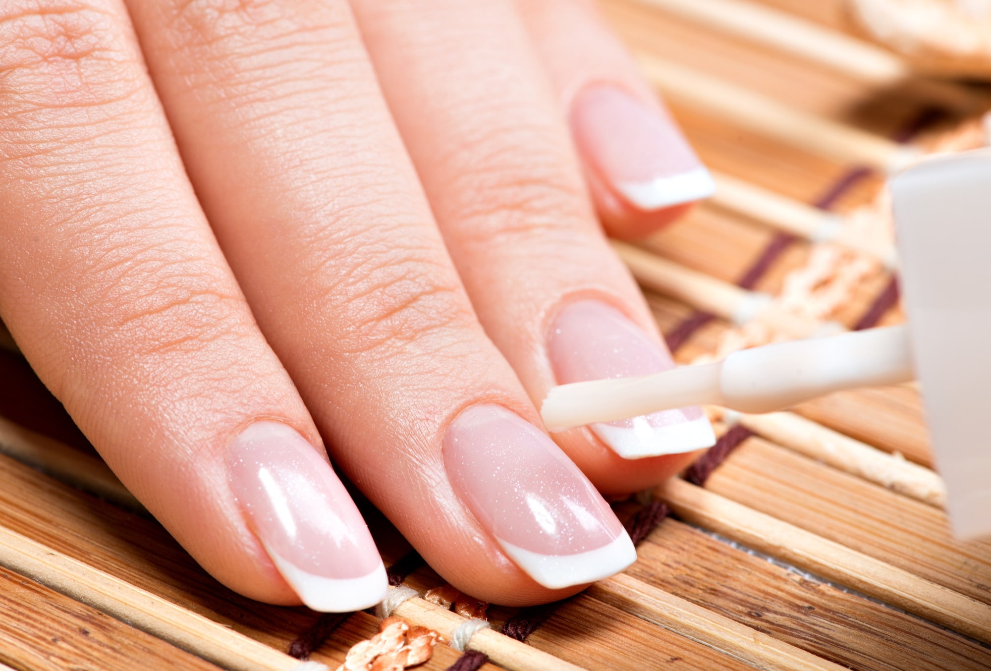 woman-nail-salon-receiving-manicure-by-beautician-beauty-treatment