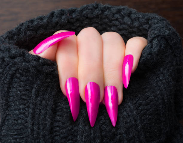 Stilleto shape long acrylic pink nails with black sweater