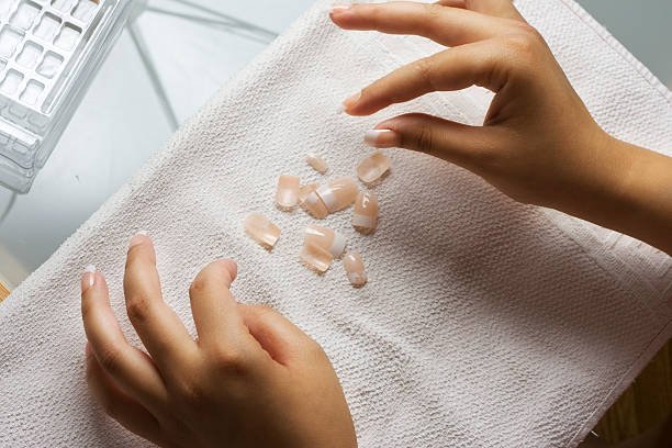 apply press on nails ,fake nails, choosing nails putting on a towel