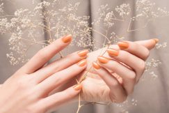 beautiful manicure types, female hands with glitter beige nail design hands hold autumn flowers