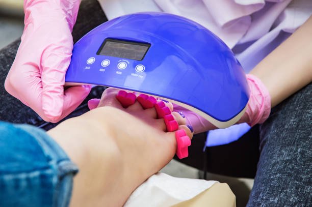 gel polish pedicure with toe separator in toes and cured in uv light