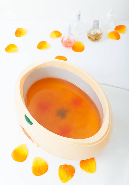 paraffin wax bowl with petals and polish in spa