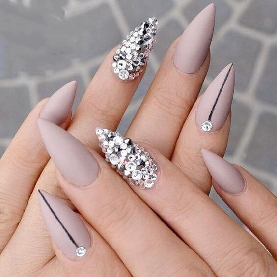 nude purple stiletto nails with silver stones