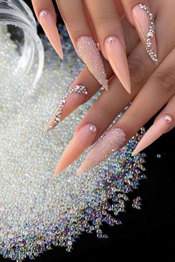 sugary stiletto long nude nails with rhinestones