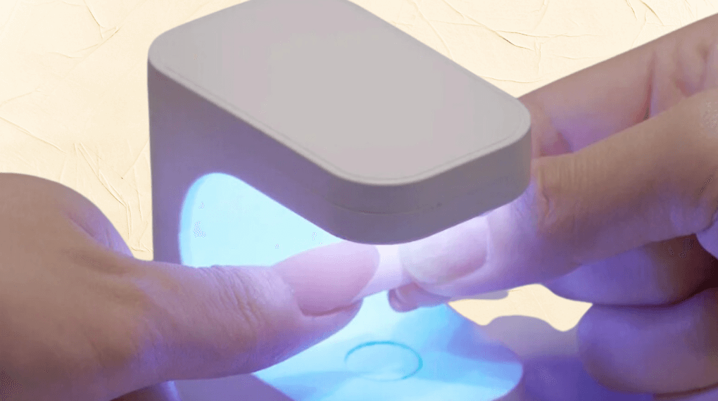 apply the press on nail and then cure under uv lamp